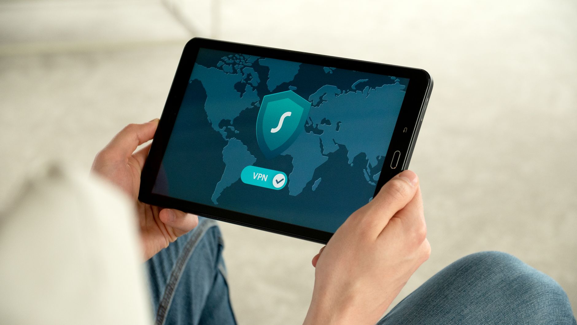 Osoba trzyma tablet z włączonym VPN jako dodatkową ochroną online