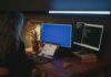 Windows, Linux czy macOS? Porównanie systemów dla programistów i administratorów Kobieta przy kilku monitorach pracująca nad bezpieczeństwem systemów